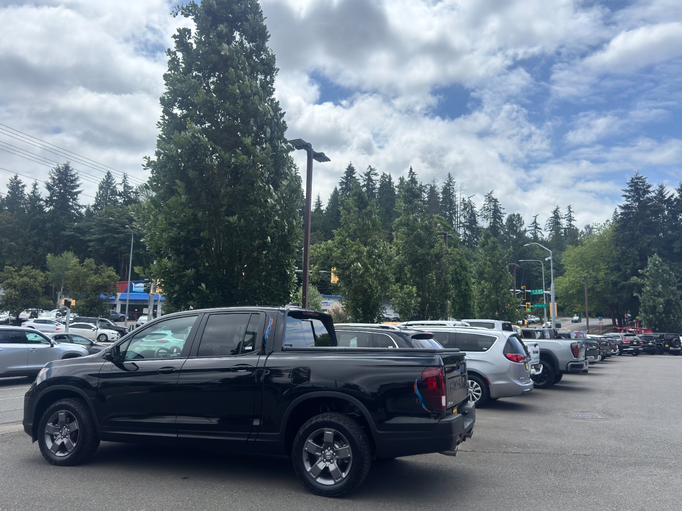 Black Honda Ridgeline pickup on the Tims Auto Buyers lot